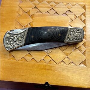 Intricately Designed Black and Silver Folding Knife
